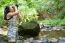 Girl Using Binoculars In Forest