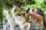 Girl Using Binoculars In Forest