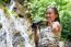 Girl Using Binoculars In Forest