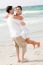 Young Couple Playing On Beach