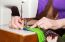 Woman's Hands Sewing On The Sewing Machine