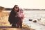 Happy Mother With Her Daughter On The Seaside In Spring