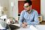 Handsome Young Businessman Working With Laptop In The Office