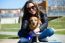 Beautiful Young Woman With Her Dog Walking In The Park