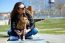 Beautiful Young Woman With Her Dog Walking In The Park