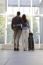 Young Couple With Luggage Waiting At Airport