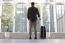 Young Man With Luggage Waiting At Airport