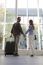 Portrait Of Young Couple With Luggage At Airport