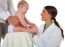 Happy Pediatrician Checking Baby Being Held By Father