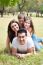 Family Lying In Grass Field