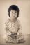 Little Asian (thai) Girl Sitting. Vintage And Retro Picture Styl