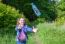 Girl Catching A Plastic Bottle