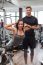 Woman With Personal Trainer  In Gym