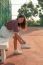 Portrait Of Beautiful Sport Girl Sitting In Tennis Courts Looking To Camera With Smiling Face Use For People And Healthy Lifestyle Activities