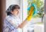 Woman Cleaning A Window With A Rag