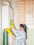 Woman Cleaning A Boiler With A Rag