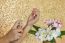 Women Hand Spraying Perfume At Wrist With Flowers In Vase And Cl