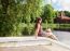 Beautiful Brunette Sitting Near The Lake