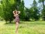 Young Beautiful Brunette Standing On The Grass