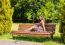 Young Beautiful Brunette Sitting On A Bench In A City Park