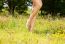 Girl Standing Barefoot On The Grass