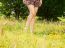 Girl Standing Barefoot On The Grass