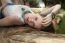 Woman On The Beach Lying On Branch