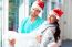 Happy Surgeon Carrying Female Doctor During Christmas