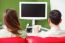 Rear View Of Young Couple Watching Tv On Sofa