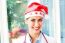 Happy Female Doctor Wearing Santa Hat