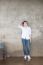 Attractive Teenage Asian Girl Standing In Front Of Grunge Concrete Wall