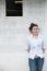 Attractive Teenage Asian Girl Standing In Front Of Grunge Concrete Wall