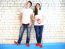 Young Smiling Couple With Red Alarm Clock