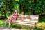 Young Beautiful Girl Sitting On A Park Bench