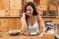 Young Woman Eating In Restaurant