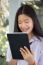 Portrait Of Thai Student Teen Beautiful Girl Using Her Tablet