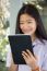 Portrait Of Thai Student Teen Beautiful Girl Using Her Tablet