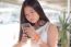 Portrait Of Thai Student Teen Beautiful Girl Using Her Phone And Smile