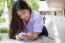 Portrait Of Thai High School Student Uniform Teen Beautiful Girl Using Her Phone And Smile