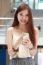 Portrait Of Thai Adult Beautiful Girl Using Her Smart Phone And Smile