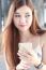 Portrait Of Thai Adult Beautiful Girl Using Her Smart Phone And Smile