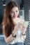 Portrait Of Thai Adult Beautiful Girl Using Her Smart Phone And Smile