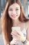 Portrait Of Thai Adult Beautiful Girl Using Her Smart Phone And Smile