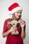 Woman In Santa Hat Holding Reindeer Toy