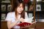 Portrait Of Thai Adult Student University Uniform Beautiful Girl Reading Red Book