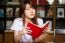 Portrait Of Thai Adult Student University Uniform Beautiful Girl Reading Red Book