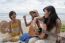 Younger Asian Woman Friend Vacation Relaxing Playing Guitar And Sing A Song On Sea Beach