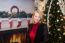 Closeup Of Blonde Female Sitting Next Christmas Tree