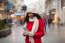 Woman In Red Coat And Wool Cap And Gloves With Smartphone In Han