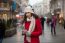 Woman In Red Coat And Wool Cap And Gloves With Smartphone In Han